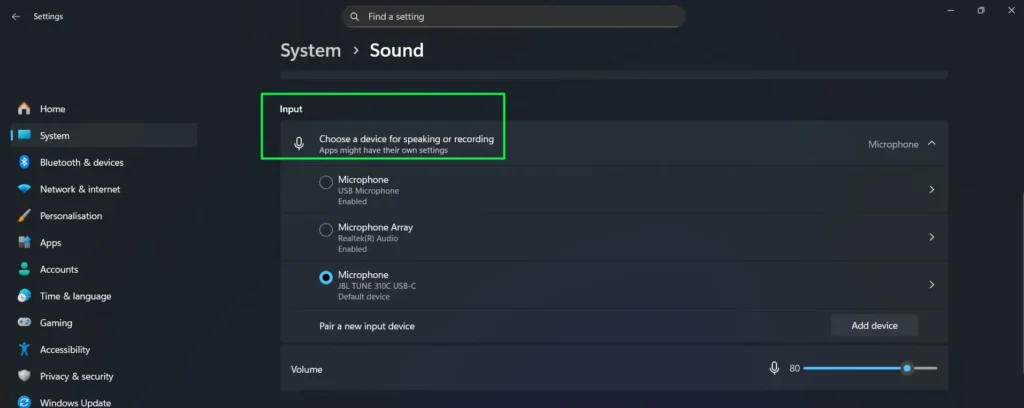 Scroll down to the ‘Input’ section and find the dropdown labeled ‘Choose a device for speaking or recording’.