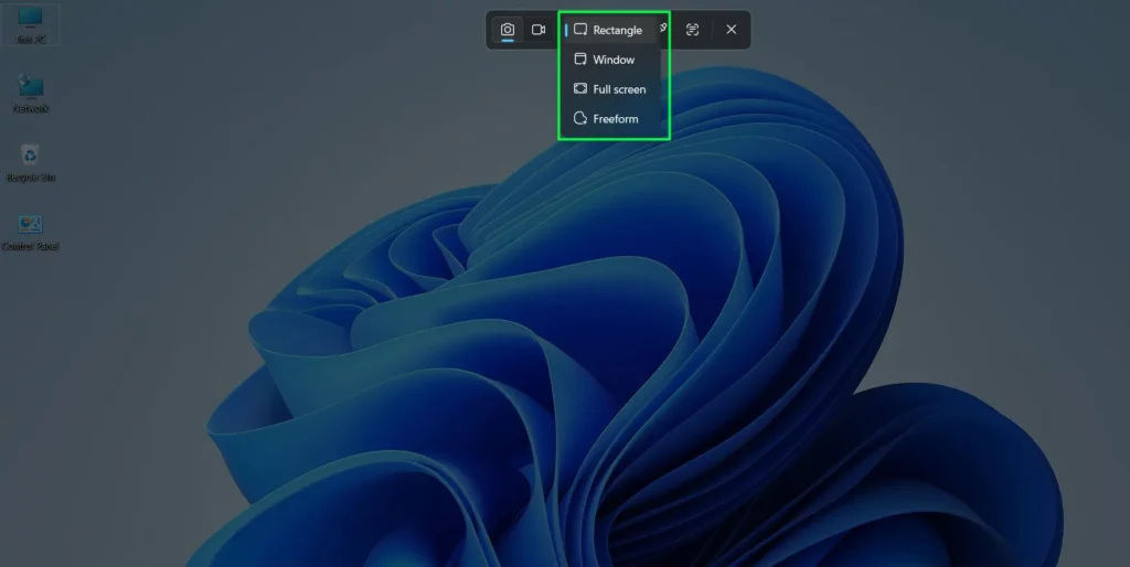 The screen dims and a toolbar appears at the top — click the rectangular snip icon -first option